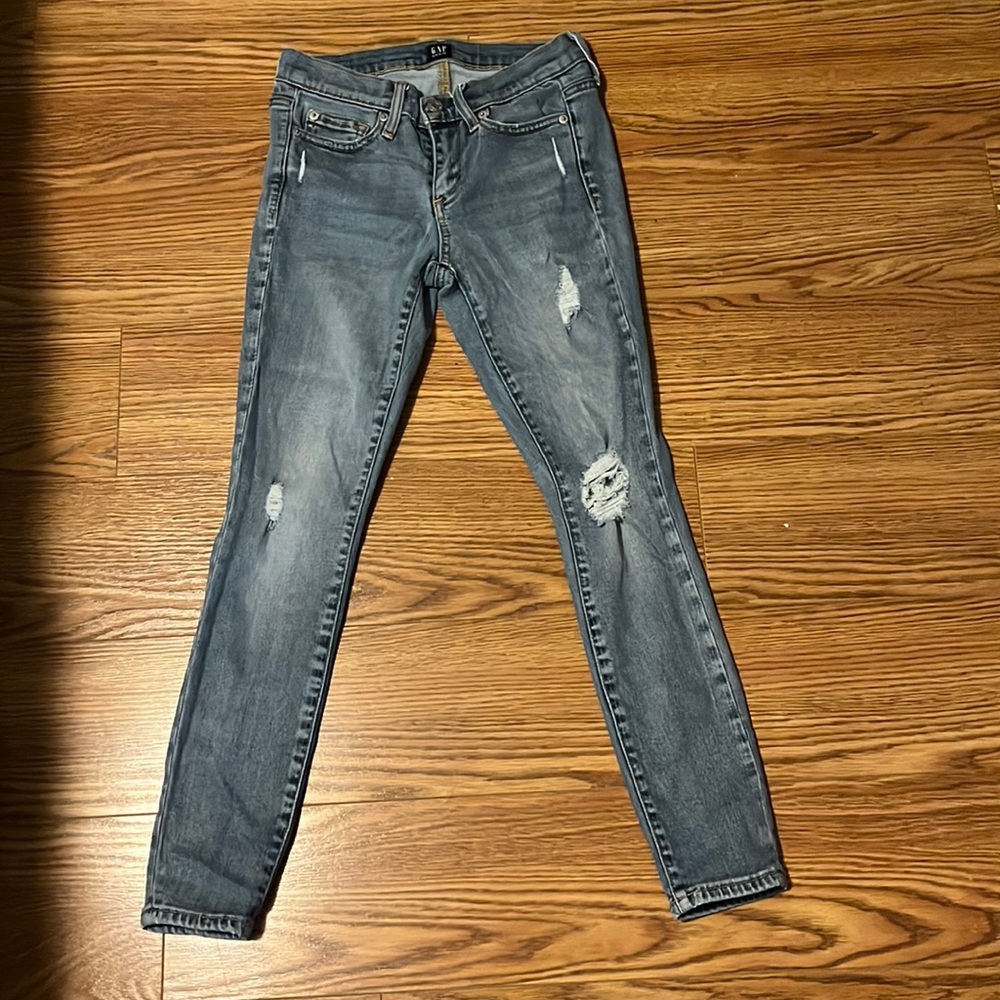 GAP Skinny jeans size 24 petite w/ rips throughout the jean in a light med wash
